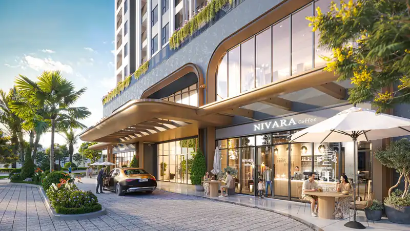 Sảnh drop-off Green Skyline: mái vòm cong đón xe, cà phê và cửa hàng ở khối đế