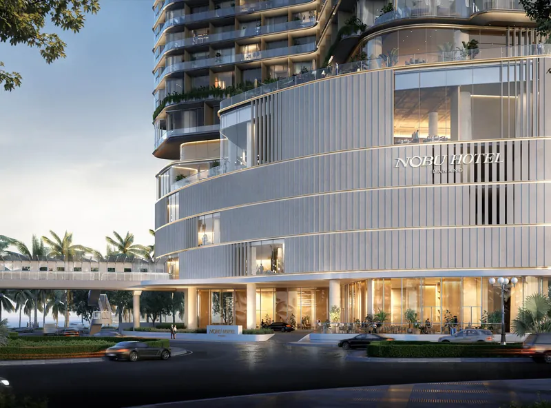 Khối đế và sảnh đón Nobu Residences Danang với mặt dựng lam cong màu trắng