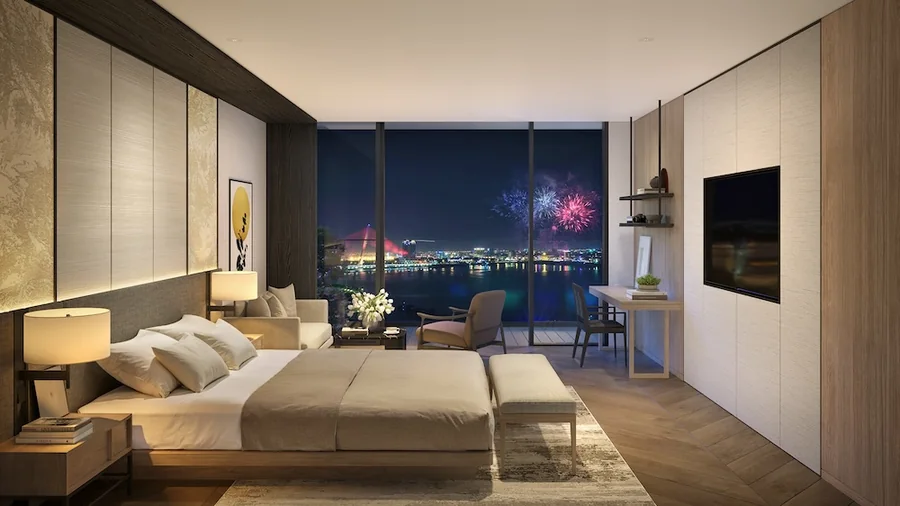 Phòng ngủ căn hộ Nobu Residences Danang nhìn ra thành phố Đà Nẵng về đêm