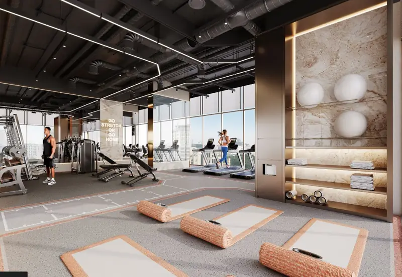 Phòng gym và yoga The Westique Residences với máy chạy bộ, khu tạ và vách kính cao từ sàn tới trần