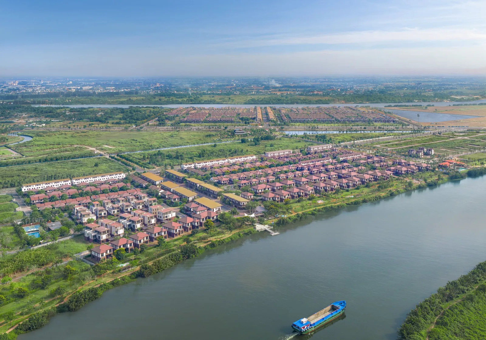 Flycam toàn cảnh đại đô thị Waterpoint bên sông với hàng trăm căn nhà đã hoàn thiện
